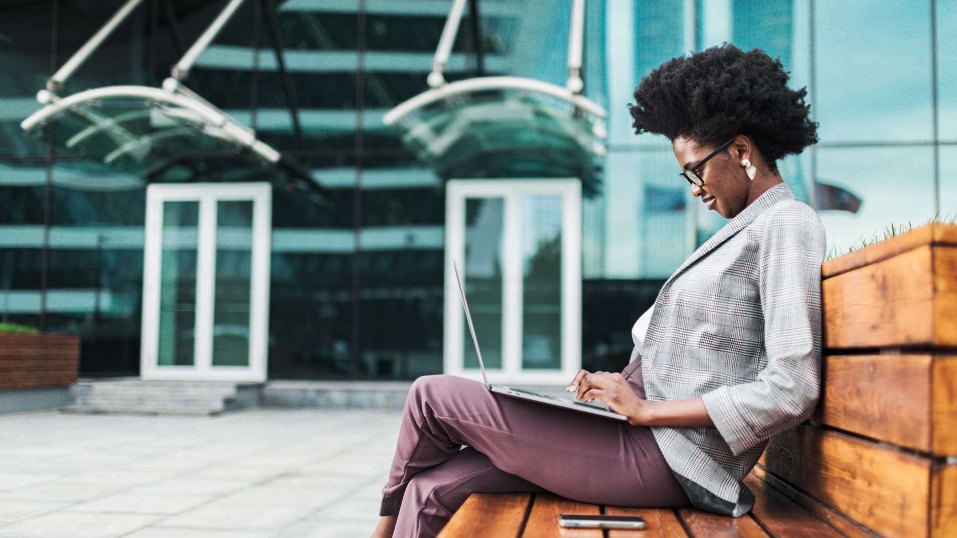 Large group of blue umbrellas with a single yellow umbrella standing out