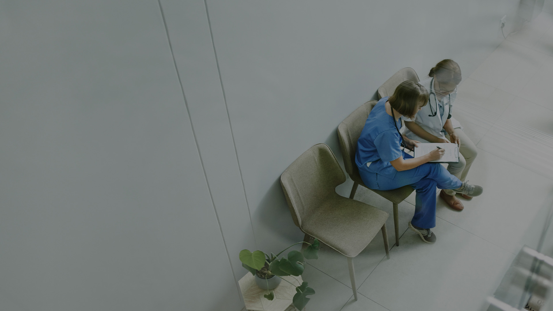 Two healthcare professionals looking at patients chart.