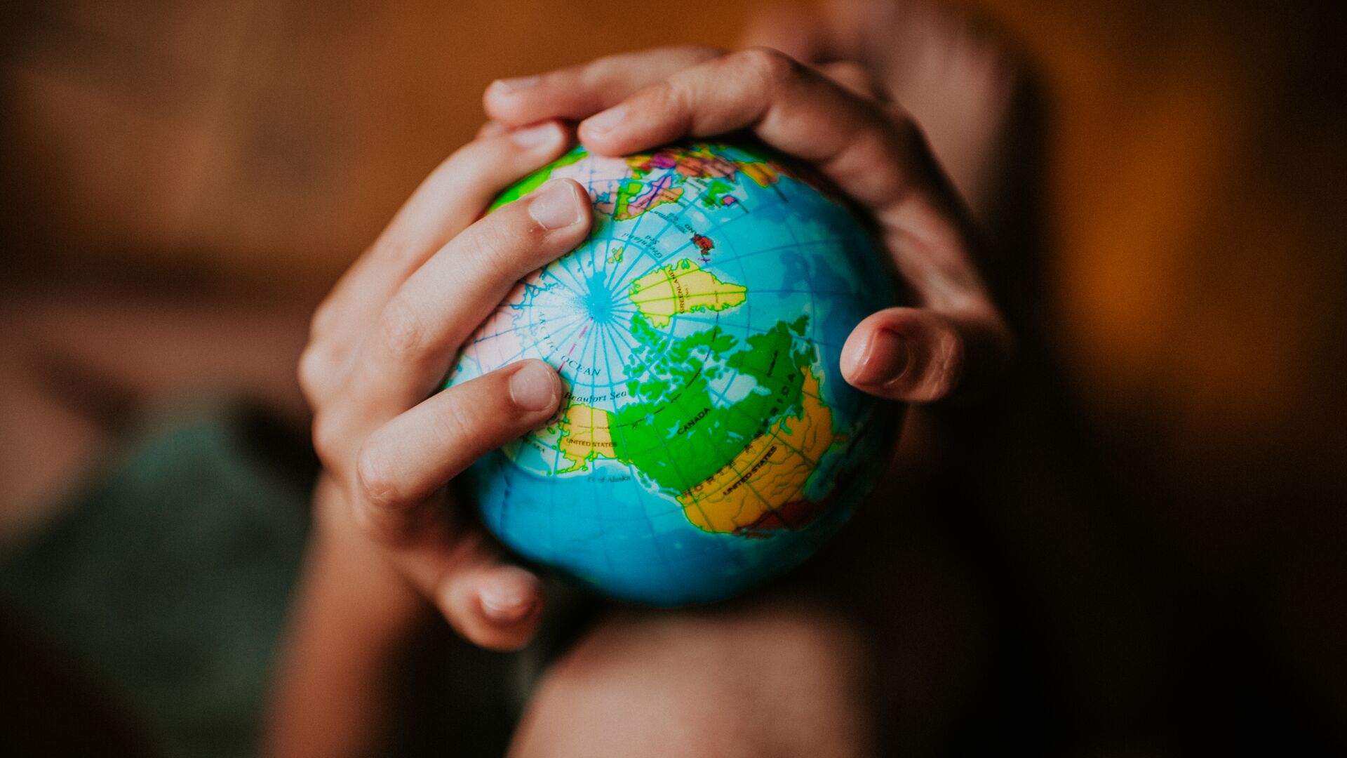 A child holding a globe of the Earth
