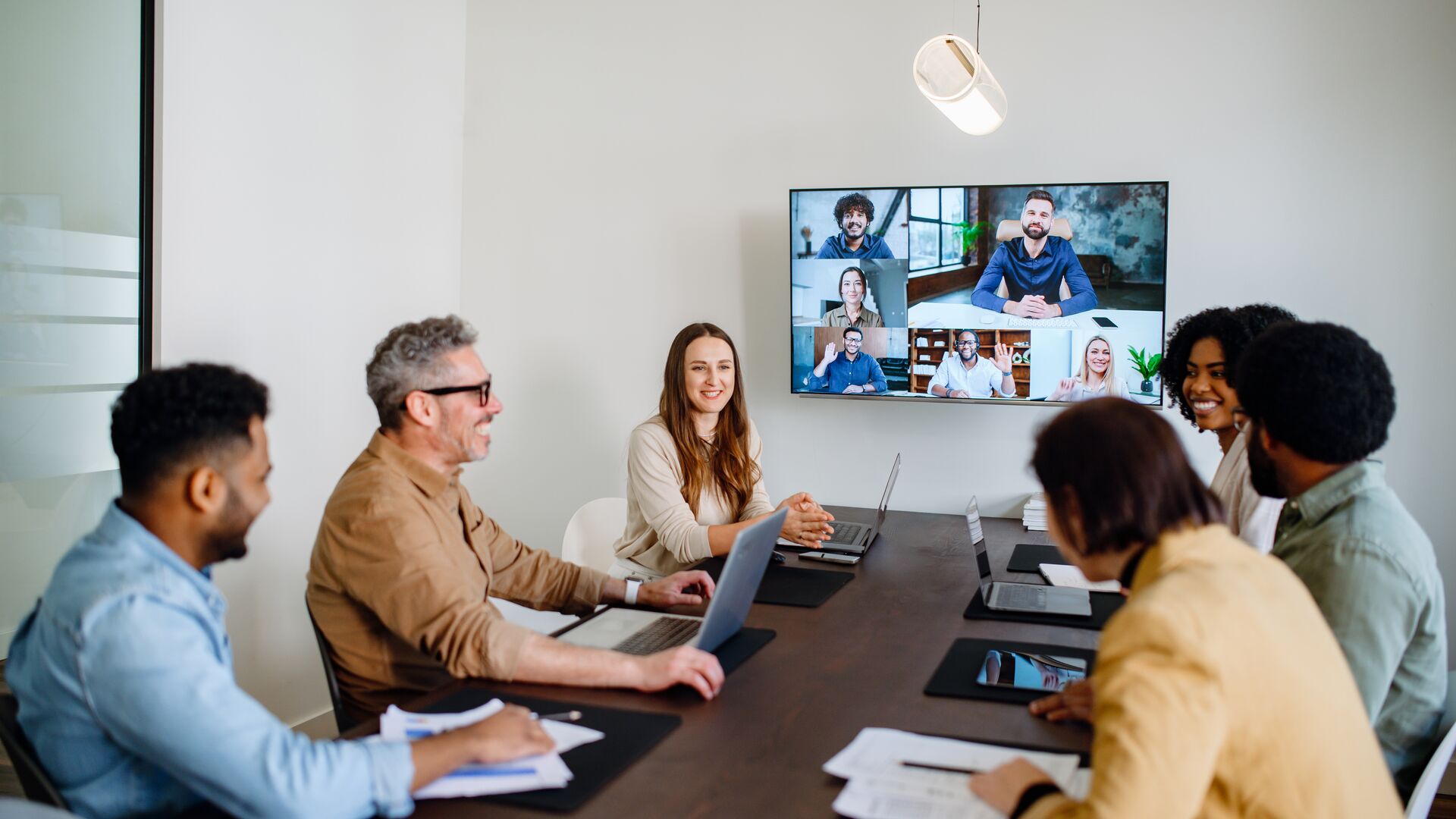 A diverse group of colleagues gathered around in a meeting.