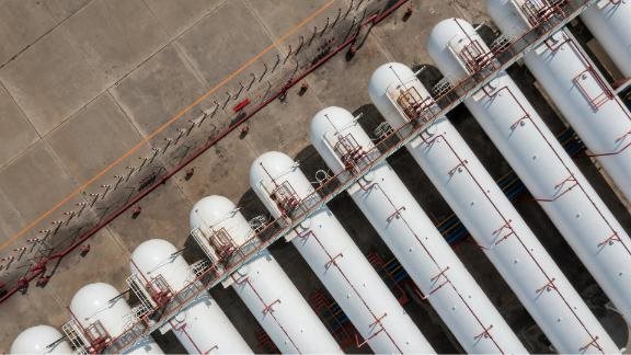 White gas tanks and pipelines at a oil and gas storage terminal company