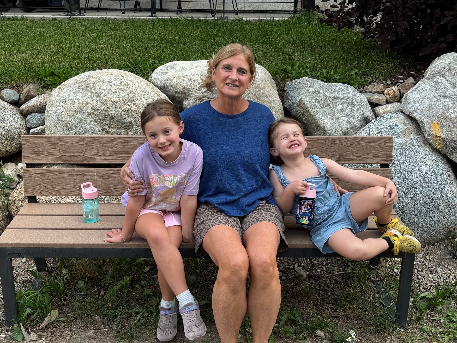 Lori Haley on a bench with her grandkids.