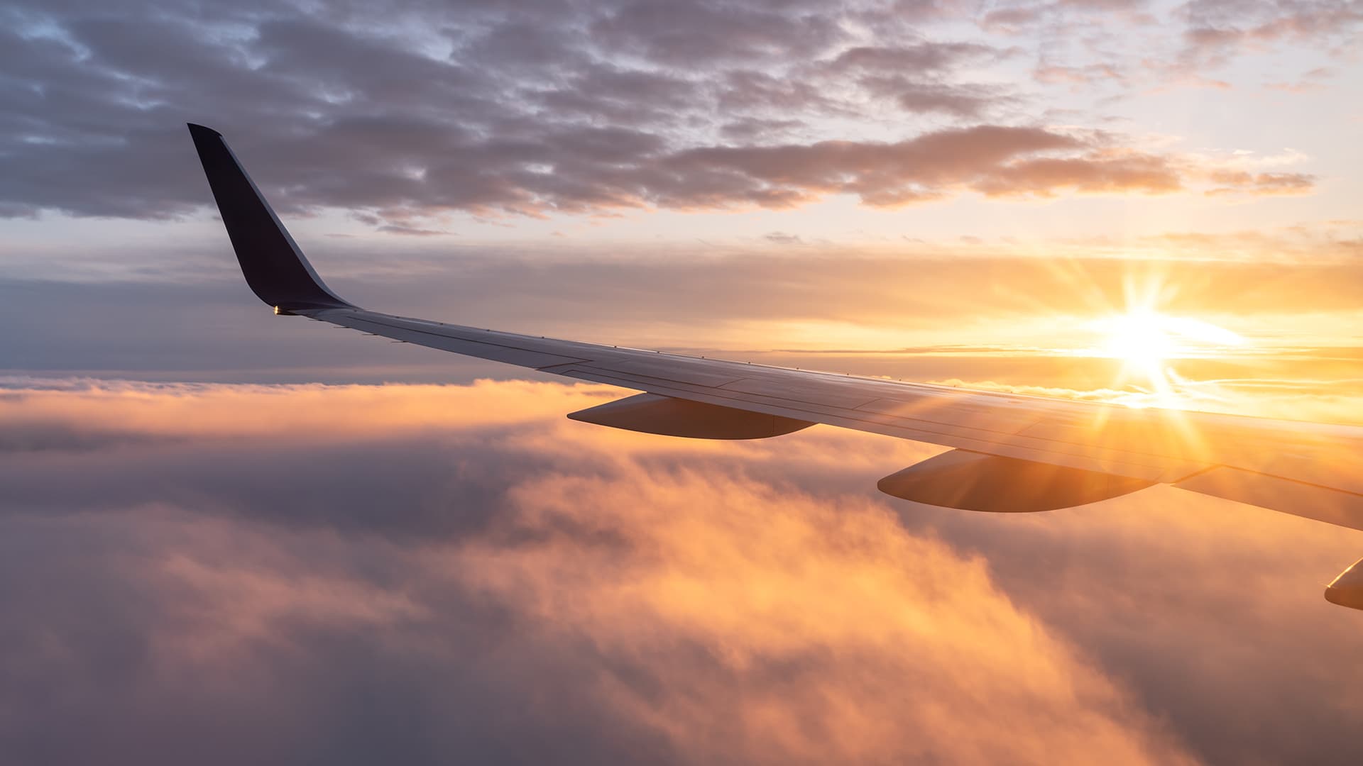 View from the airplane with the sun rising over the horizon 