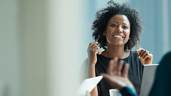 A business woman smiling at her colleagues.