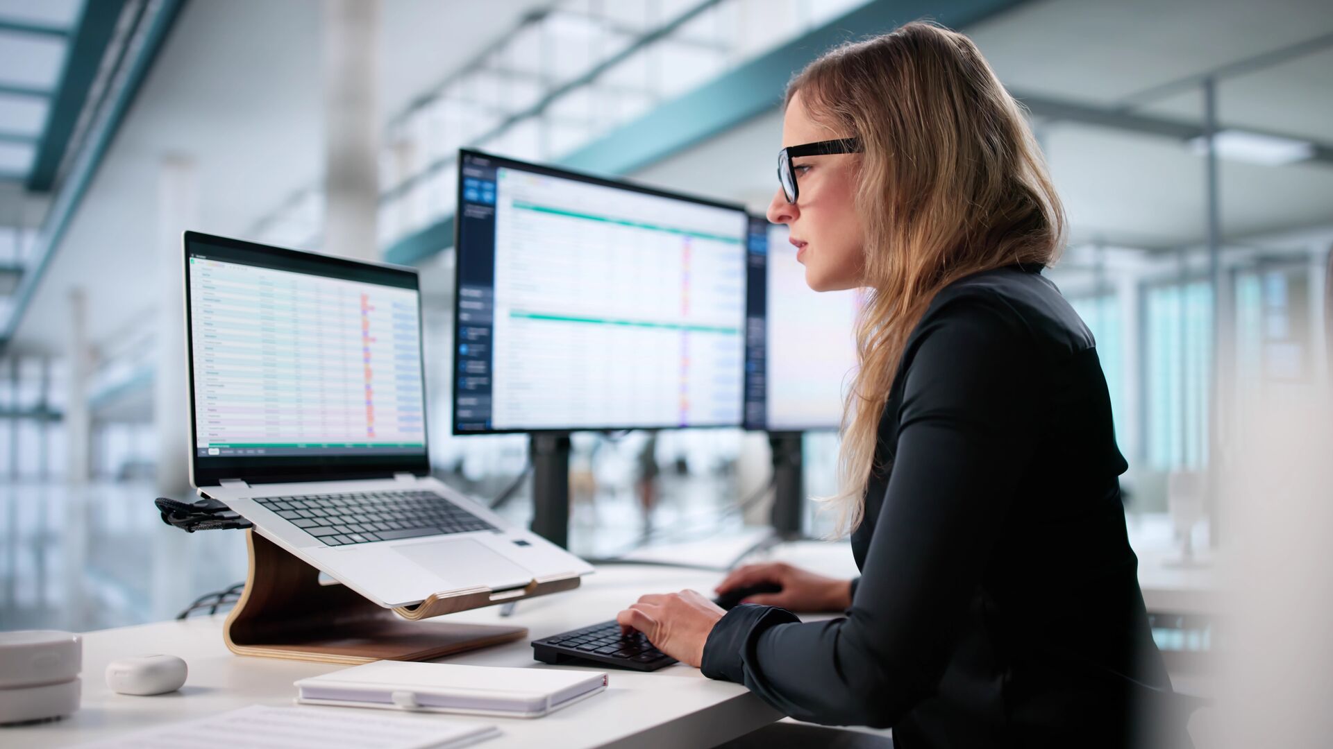 Woman analyzing billing codes on a spreadsheet.