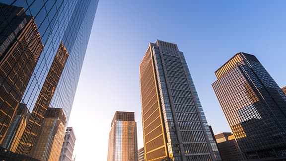 Low angle view of modern corporate skyscrapers, with modern glass windows facade and urban architectural designs.