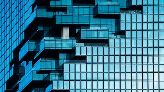 The glass exterior of a modern looking building