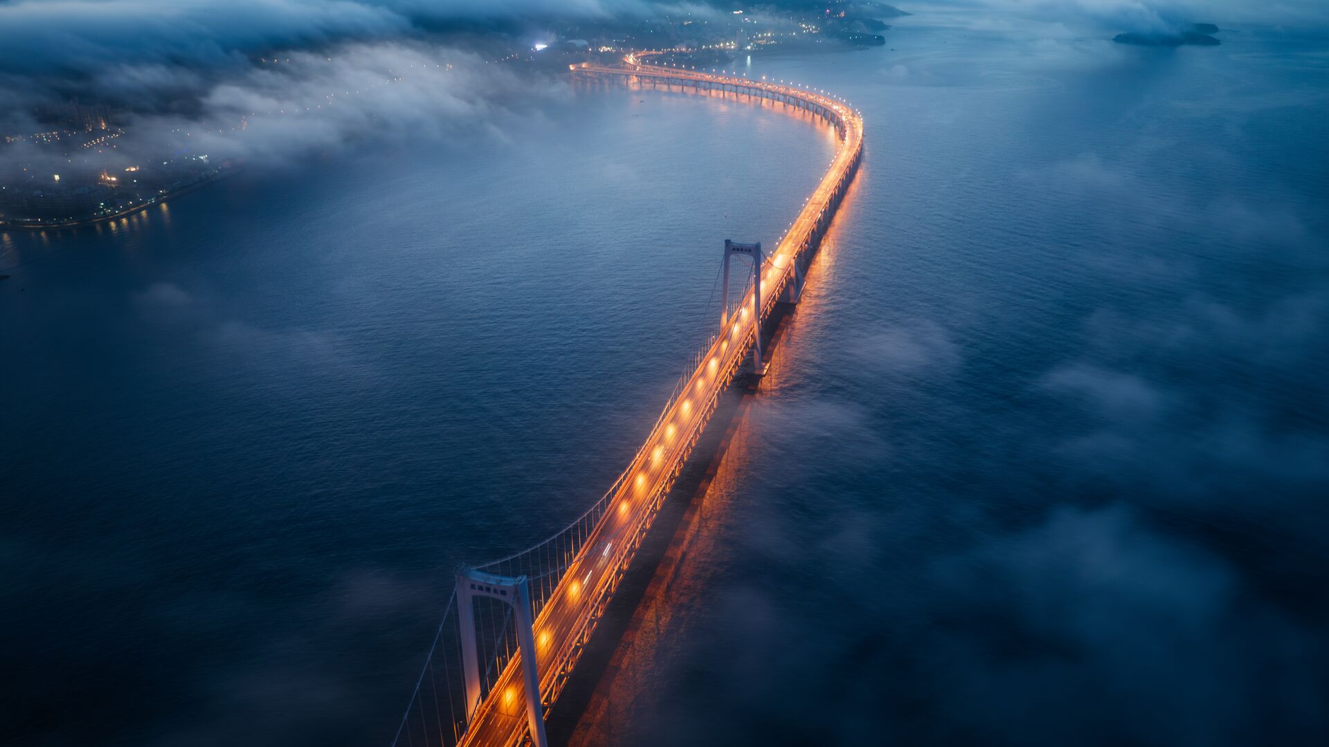 Bridge shrouded in fog at night