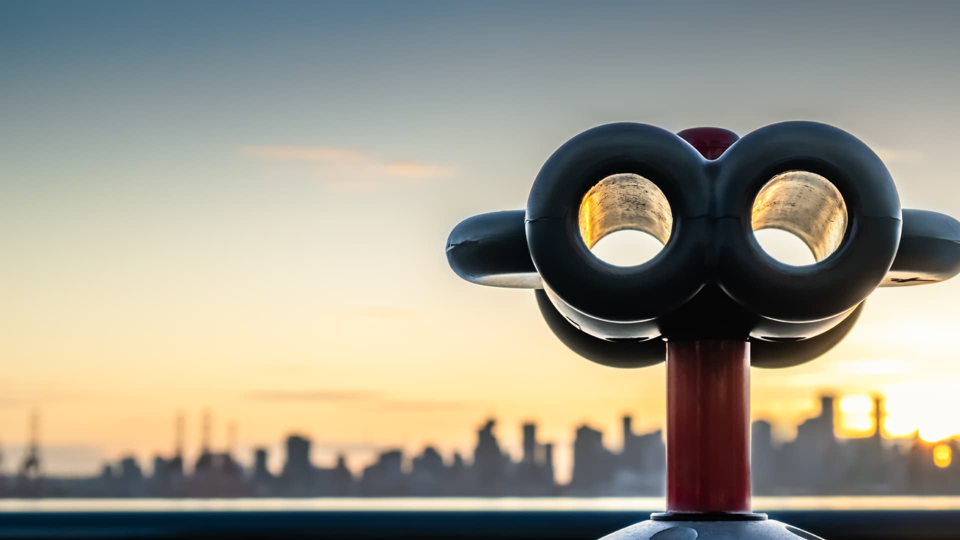 Binoculars with skyline of city.