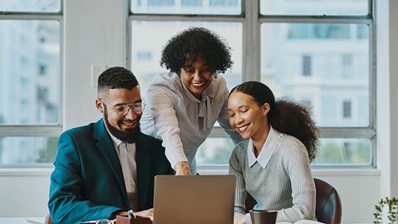 An HR professional helping two new interns get started on their first day.