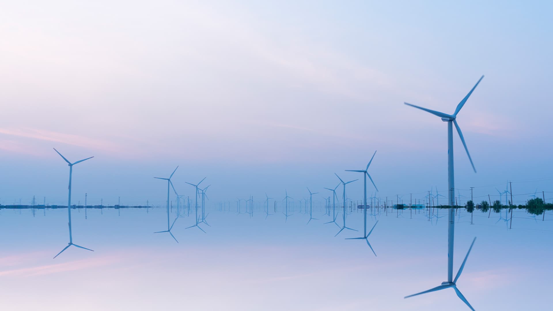 Wind turbines that are sitting along a coast