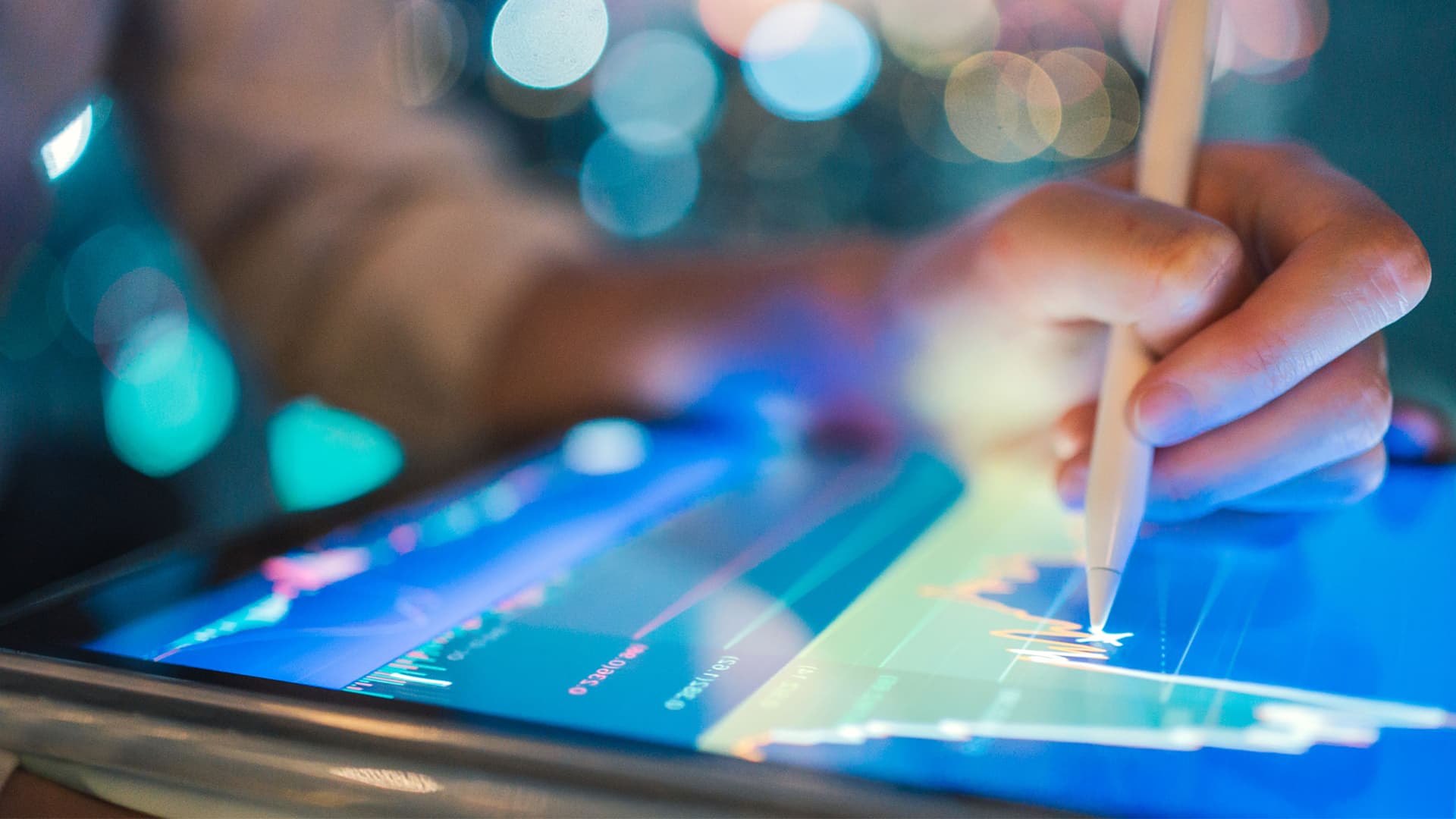 Close up of someone using a stylus on a tablet
