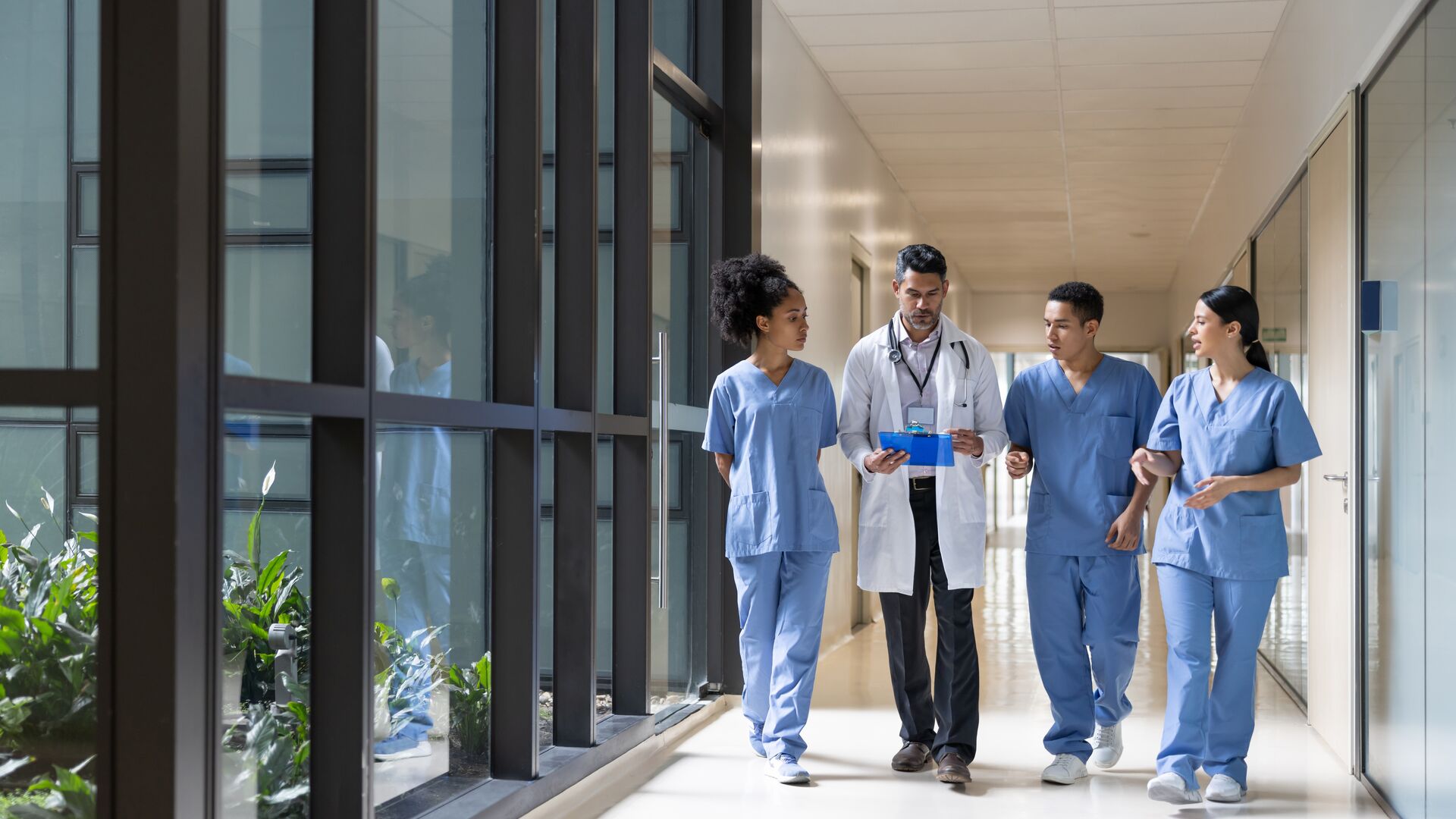 A group of physicians looking at a patients chart.